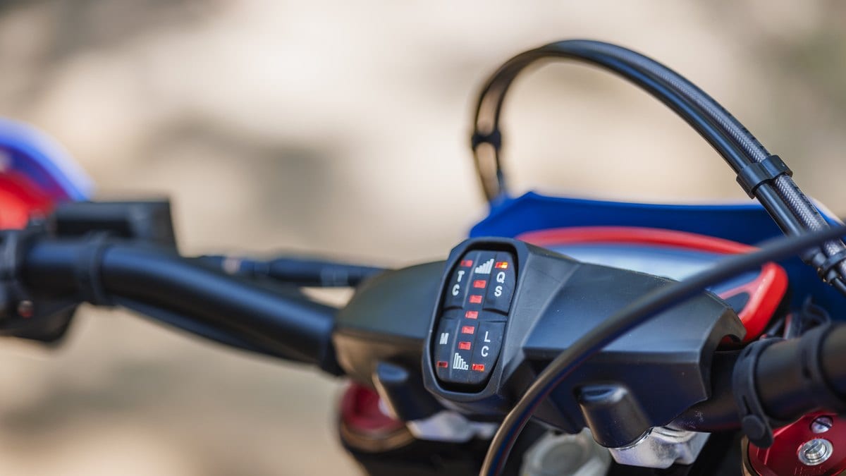 Close-up of a dirt-bike digital dash and handlebar switchgear